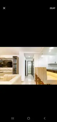 a kitchen and a living room with chairs and a table at Marinares apartamento in Cartagena de Indias