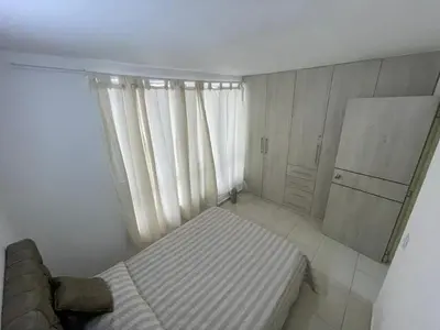 a small bedroom with a bed and a refrigerator at Brisas del caribe in Cartagena de Indias