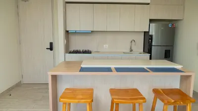 a kitchen with two chairs and a counter with a counter top at New & Comfortable Apartment 2 BR In Cielo Mar in Cartagena de Indias