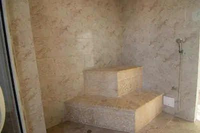 a walk in shower with two stone steps in a bathroom at New & Comfortable Apartment 2 BR In Cielo Mar in Cartagena de Indias