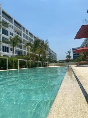 a swimming pool in front of a building at Apartamento en Playa Manzanillo in Cartagena de Indias