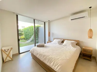 a bedroom with a large bed and a large window at Apartamento en Playa Manzanillo in Cartagena de Indias