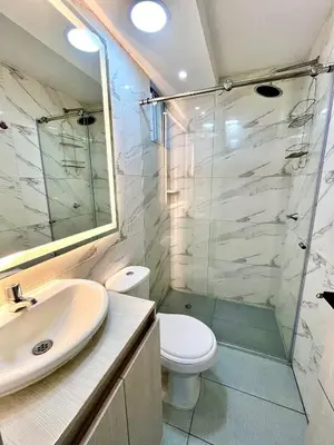 a bathroom with a toilet and a glass shower at Luxury loft with pool in Barranquilla