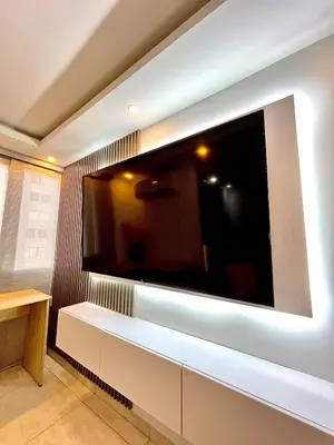 a large flat screen tv on a wall at Luxury loft with pool in Barranquilla