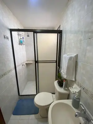 a bathroom with a shower and a toilet and a sink at Encanto Barranquillero! in Barranquilla