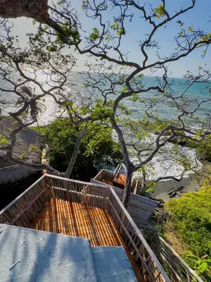 a set of stairs with a view of the ocean at COCO SALVAJE Tree House in La Rada