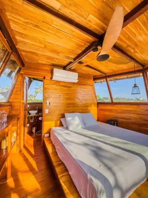 a bedroom with a bed in a wooden room at COCO SALVAJE Tree House in La Rada