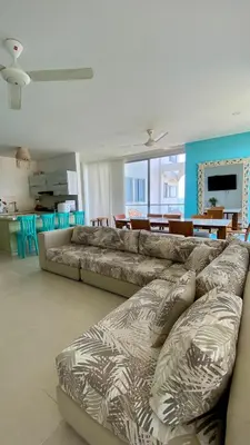 a living room with a couch and a dining room at Fontainebleu in Coveñas