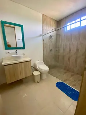 a bathroom with a shower and a toilet and a sink at Fontainebleu in Coveñas