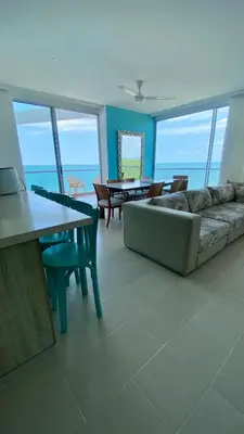 a living room with a couch and a table at Fontainebleu in Coveñas