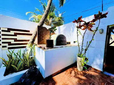 an outdoor area with plants and a brick oven at Auaecoco Hotel in Cartagena de Indias