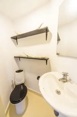 a bathroom with a sink and a toilet and a mirror at Auaecoco Hotel in Cartagena de Indias