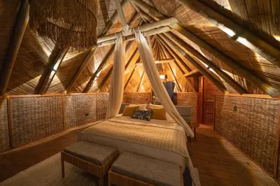 a bed in the middle of a room at Isla Corona in Baru