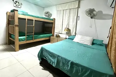 a bedroom with a bed and a bunk bed at Casa campestre Magyli in Puerto Salgar