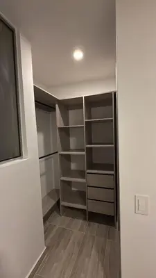 a walk in closet with shelves and a window at Margarita's apartment in Puerto Colombia