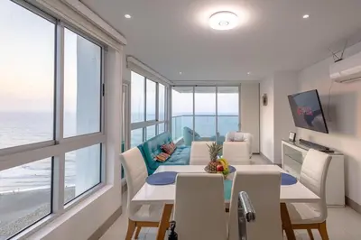 a dining room with a view of the ocean at Majestic apt with an ocean view Palmetto Beach in Cartagena de Indias