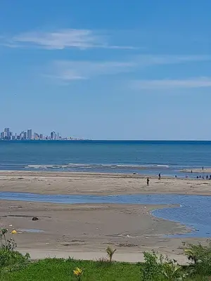 a beach with people in the water and a city at Beach, kitesurfing loft en Cartagena, La Boquilla in Cartagena de Indias