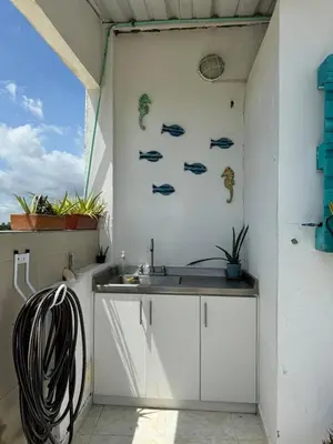 a kitchen with a sink in a room with a window at Beach, kitesurfing loft en Cartagena, La Boquilla in Cartagena de Indias