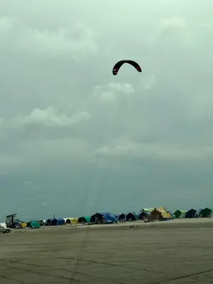 a person flying a kite in the sky at Beach, kitesurfing loft en Cartagena, La Boquilla in Cartagena de Indias
