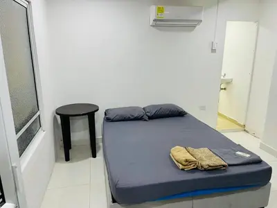 a small bed in a room with a stool and a bed sidx sidx at Habitación cerca a la playa 105 in Cartagena de Indias