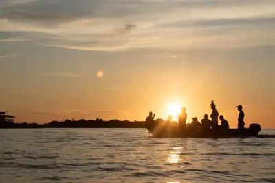 people on a boat in the water at sunset at Casa Acuarimantima in Tintipan Island