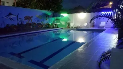 a swimming pool at night with lights in a house at Apartamento con piscina in San Silvestre