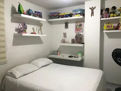 a bedroom with a bed with white shelves at Apartamento Carnavalero calle 72, ubicación privilegiada eventos de carnaval zona norte in Barranquilla