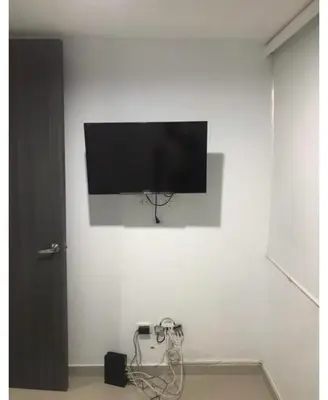 a flat screen tv hanging on a white wall at Barranquilla Carnival 4 PX in Barranquilla