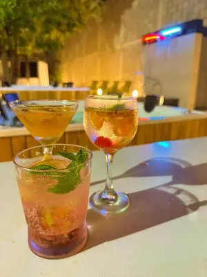 two glasses of drinks sitting on a table at Pop Art Hotel CLC Puerto Mamonal Cartagena in Cartagena de Indias