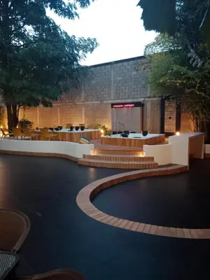 a courtyard with tables and chairs in a building at Pop Art Hotel CLC Puerto Mamonal Cartagena in Cartagena de Indias