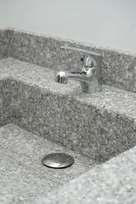 a sink with a faucet and a drain at Hotel INdustrial in Sincelejo