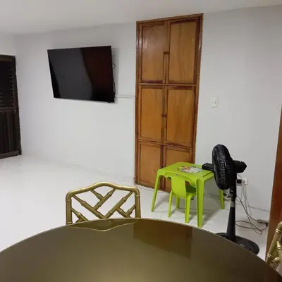 a room with a table and chairs and a television at Apartamento al norte de Barranquilla in Barranquilla