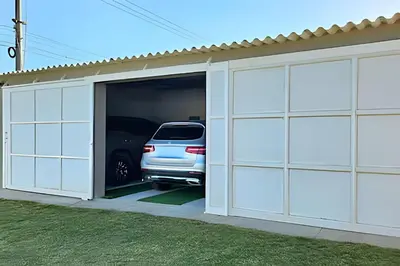 a car is parked inside of a garage at Casa de playa privada Sabanilla 4 cuadras del mar in Maizal