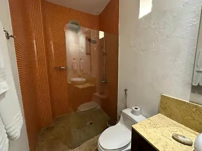 a bathroom with a shower and a toilet and a sink at 5 BR Villa inside of the walled city in Cartagena de Indias