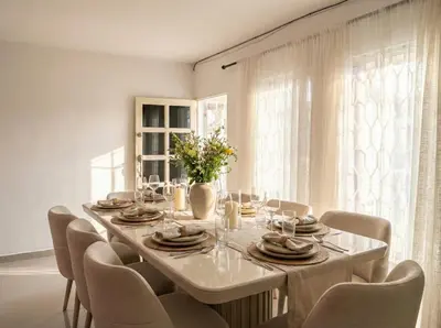 a dining room table with chairs and a large window at Casa Plenitud Lux in Cartagena de Indias