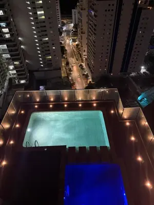 a swimming pool on top of a building at night at Beautiful Ocean view apartment in Cartagena de Indias