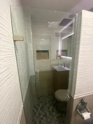 a bathroom with a shower and a toilet and a sink at Casa de lujo en barrio popular in Cartagena de Indias