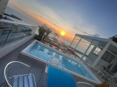 a swimming pool on top of a building next to the ocean at HS-C Habitación Cuádruple con aire acondicionado y piscina in Cartagena de Indias