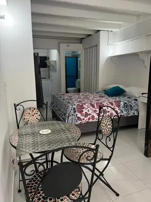a room with a table and chairs and a bed at Apartaestudio Marbella in Cartagena de Indias