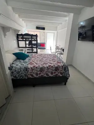 a bedroom with a bed and a table and chairs at Apartaestudio Marbella in Cartagena de Indias