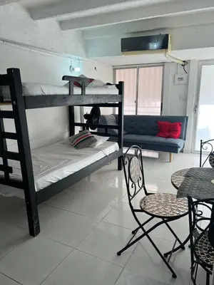 a room with two bunk beds and a table and chairs at Apartaestudio Marbella in Cartagena de Indias