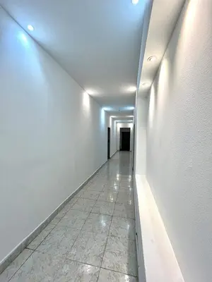 a long hallway with white walls and a tile floor at Comfortable loft in Barranquilla in Barranquilla