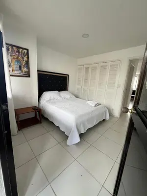 a bedroom with a white bed in a room at Portofino Apartments in Cartagena de Indias
