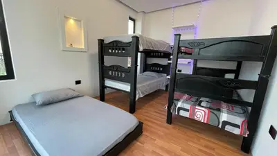 a room with two bunk beds and a bed at Habitacion con piscina-jacuzzi-lavadora disponible in Juan de Acosta