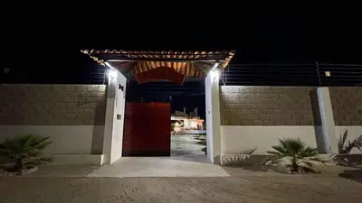 a entrance to a house at night with lights at Habitacion con piscina-jacuzzi-lavadora disponible in Juan de Acosta