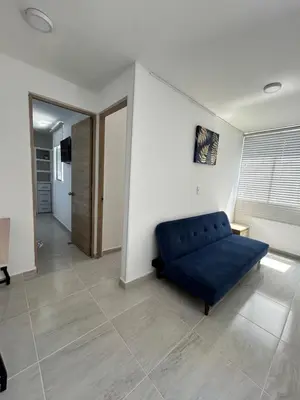 a living room with a blue couch in a room at Cómodo apartamento en el norte de Barranquilla in Barranquilla