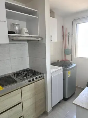 a kitchen with a stove top oven in a kitchen at Cómodo apartamento en el norte de Barranquilla in Barranquilla