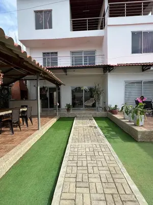 a house with a green lawn in front of it at Cabaña Don Jerónimo in Santa Veronica