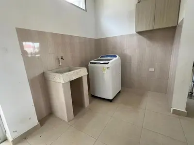 a laundry room with a small refrigerator and a sink at Cabaña Don Jerónimo in Santa Veronica