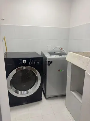 a small kitchen with a washing machine and a sink at Apartaestudio altos de riomar in Barranquilla